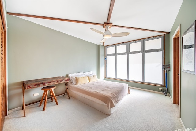 carpeted bedroom featuring ceiling fan and lofted ceiling with beams