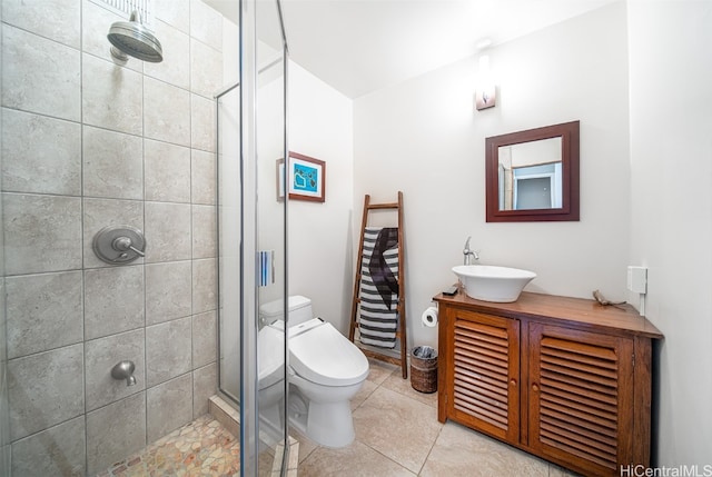 bathroom with toilet, walk in shower, vanity, and tile patterned floors