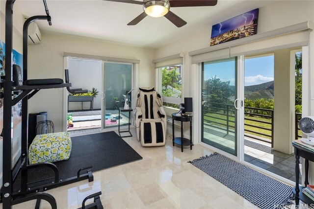 workout room featuring a mountain view, a healthy amount of sunlight, and ceiling fan