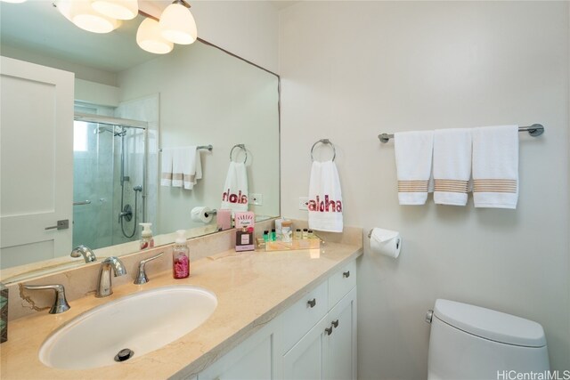 bathroom featuring vanity, toilet, and an enclosed shower