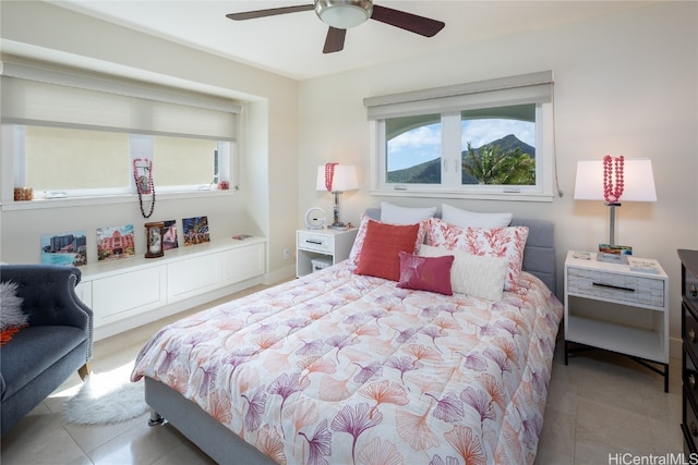 tiled bedroom with ceiling fan