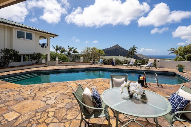 view of pool with a patio and a mountain view