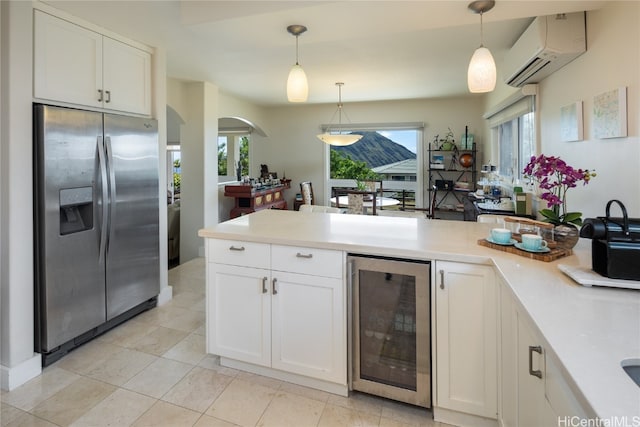 kitchen featuring wine cooler, a wealth of natural light, pendant lighting, and stainless steel fridge