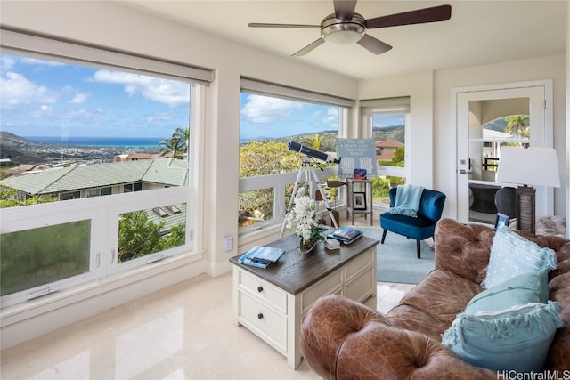 sunroom with ceiling fan and a wealth of natural light