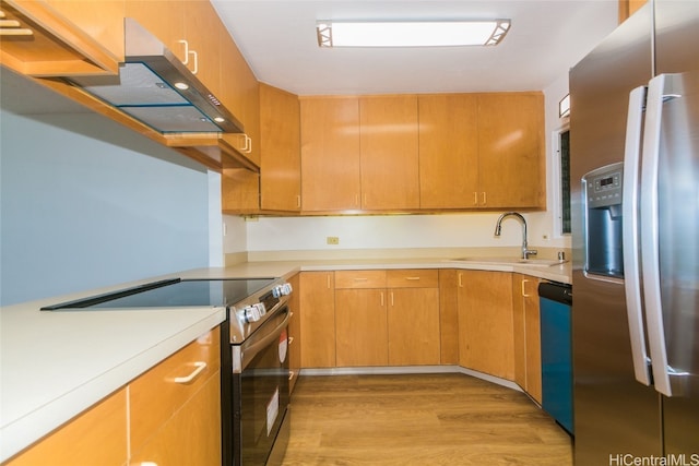 kitchen featuring light hardwood / wood-style flooring, extractor fan, appliances with stainless steel finishes, and sink