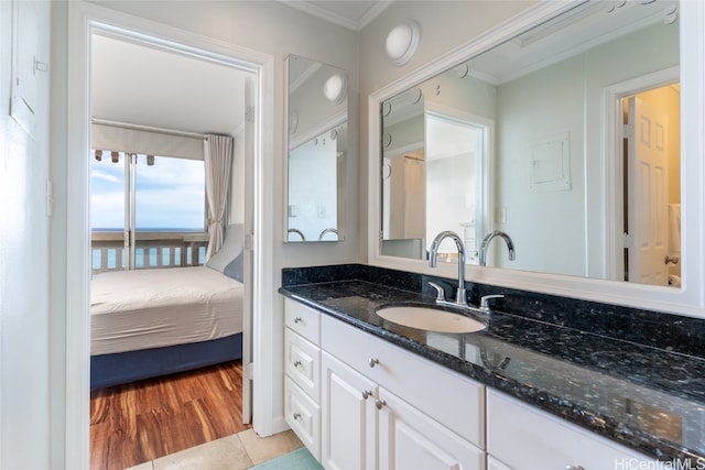 bathroom featuring vanity, hardwood / wood-style flooring, and ornamental molding