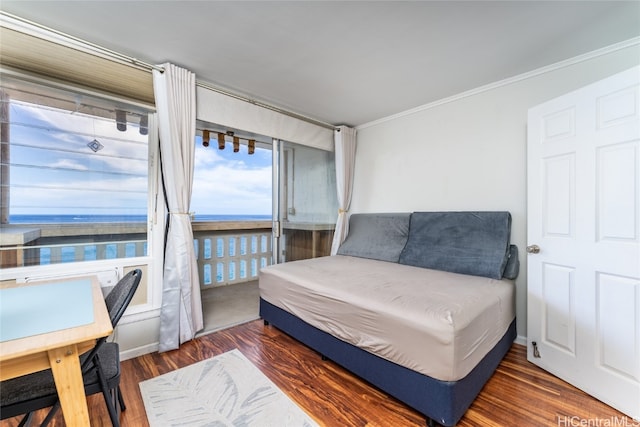 bedroom featuring crown molding, a water view, and dark hardwood / wood-style flooring