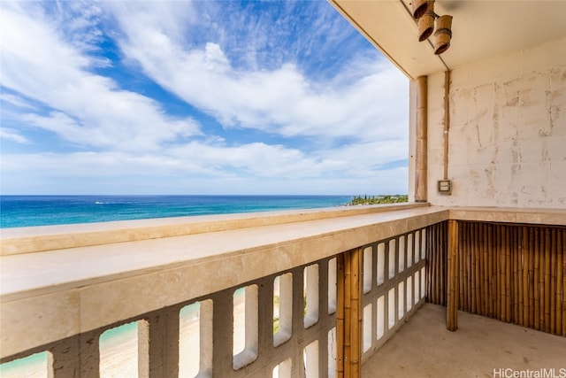 balcony featuring a water view and a view of the beach