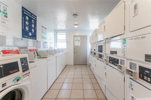 kitchen with white cabinetry, washing machine and dryer, light tile patterned flooring, and stacked washer and clothes dryer