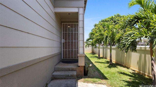 entrance to property with a lawn