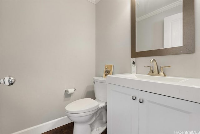 bathroom with hardwood / wood-style floors, toilet, vanity, and ornamental molding