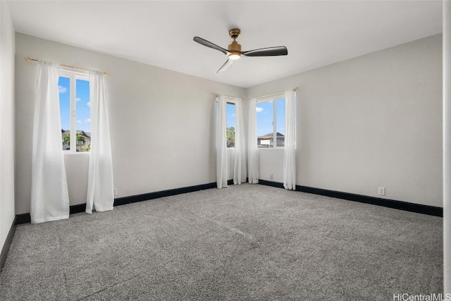 empty room with ceiling fan and carpet