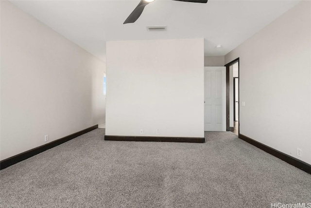 carpeted spare room with ceiling fan