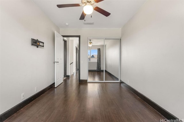 unfurnished room with dark wood-type flooring