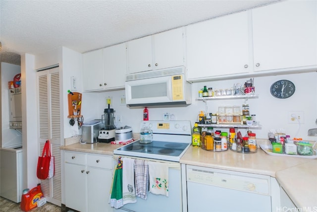 kitchen featuring white appliances, hardwood / wood-style flooring, white cabinetry, and a textured ceiling