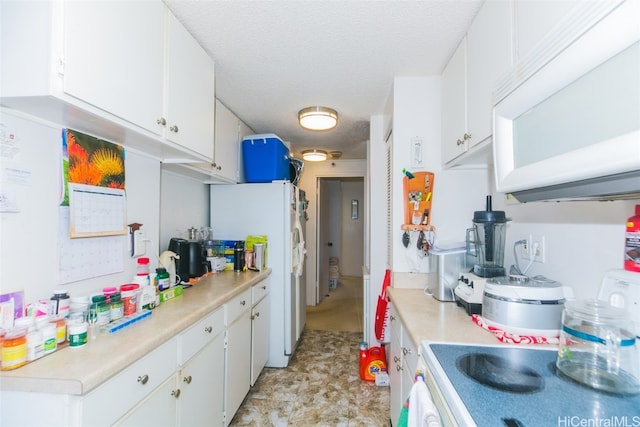 kitchen with white cabinets, a textured ceiling, and white appliances