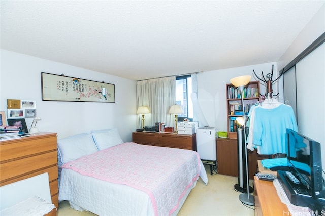 carpeted bedroom with a closet and a textured ceiling