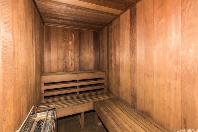 view of sauna with wood walls and wooden ceiling