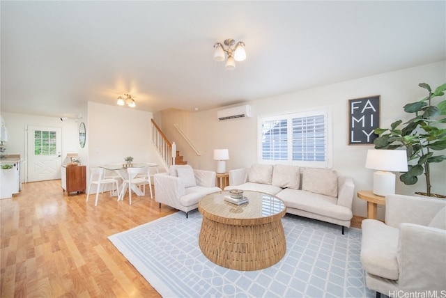 living room with a wall mounted AC and hardwood / wood-style flooring