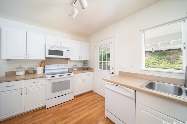 kitchen featuring track lighting, white cabinetry, light hardwood / wood-style flooring, sink, and white appliances