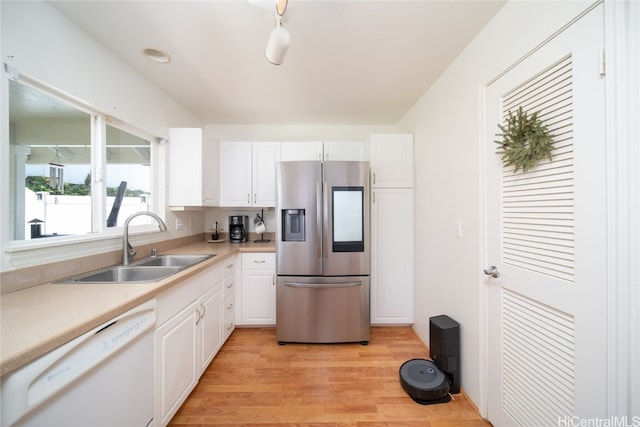 kitchen with light hardwood / wood-style flooring, white cabinets, white dishwasher, and stainless steel fridge with ice dispenser