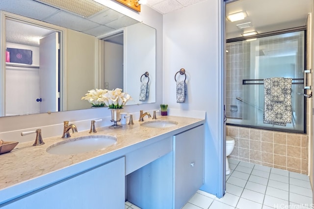 full bathroom with toilet, vanity, combined bath / shower with glass door, and tile patterned flooring