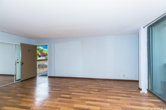 empty room featuring dark hardwood / wood-style flooring