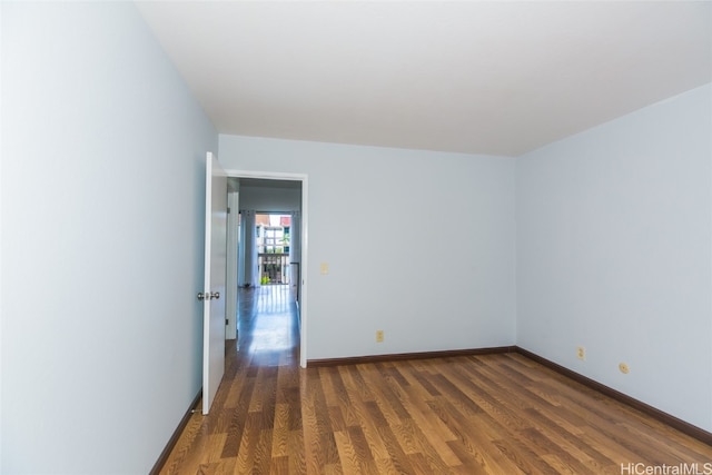 spare room with dark hardwood / wood-style flooring