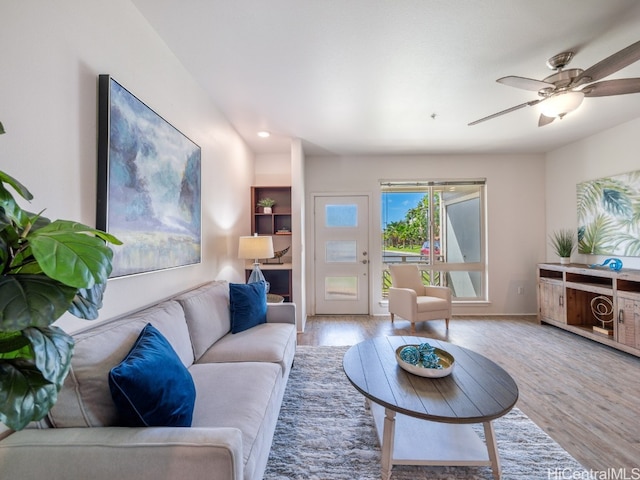 living room with light hardwood / wood-style floors and ceiling fan