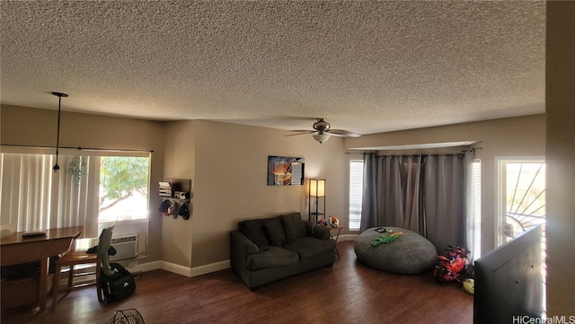 living room with a textured ceiling, a healthy amount of sunlight, and dark hardwood / wood-style flooring