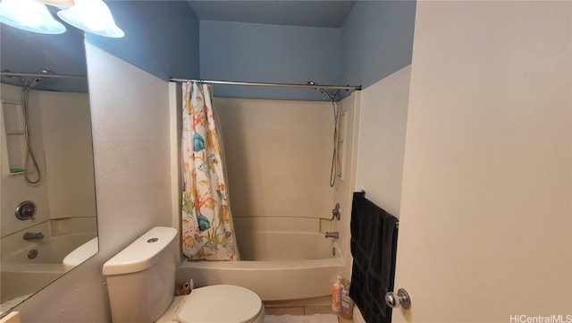 bathroom with tile patterned floors, shower / bath combo, and toilet