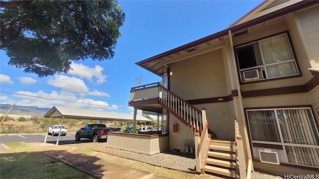 view of home's exterior with a mountain view and a carport