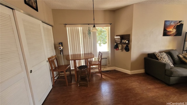 dining area featuring a textured ceiling and dark hardwood / wood-style floors