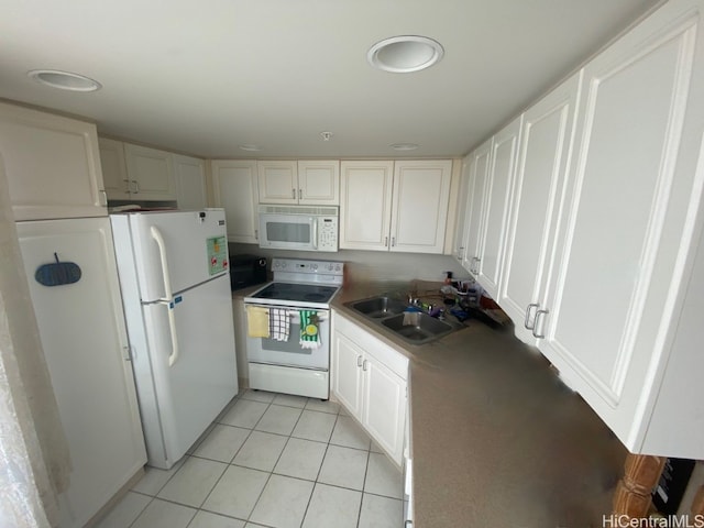 kitchen with white cabinets, sink, light tile patterned floors, and white appliances