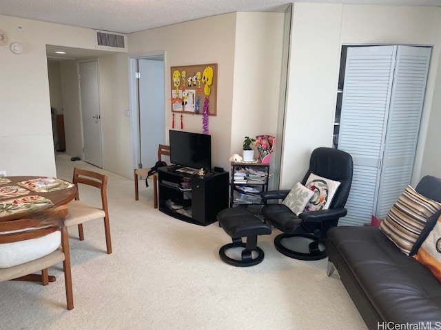 carpeted living room with a textured ceiling