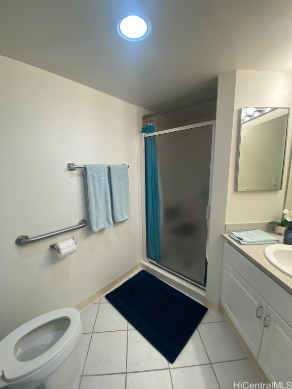 bathroom featuring toilet, a shower with curtain, vanity, and tile patterned flooring