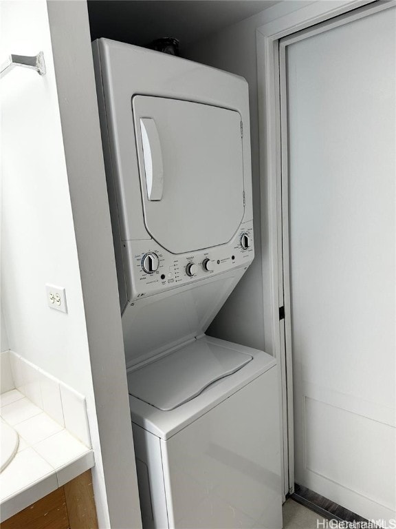 laundry room featuring stacked washer and dryer