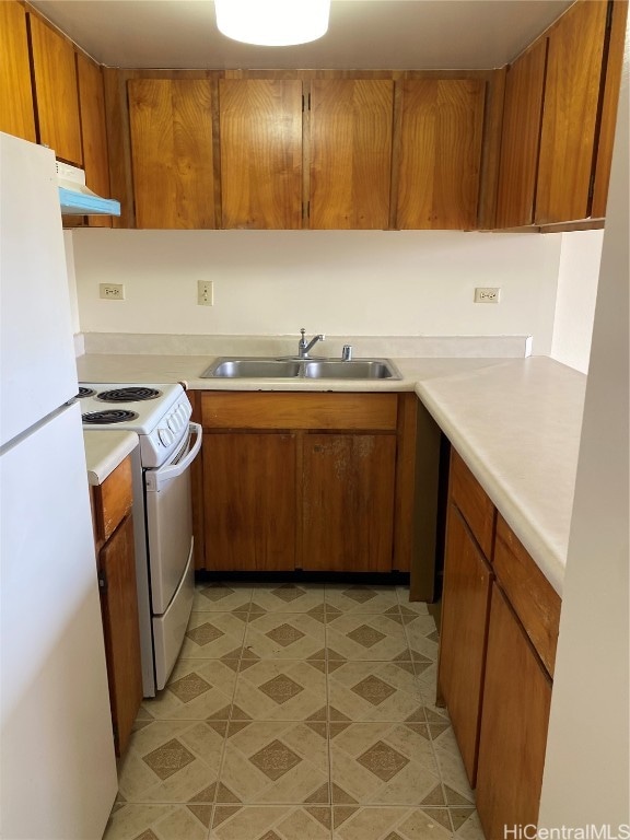 kitchen with sink and white appliances