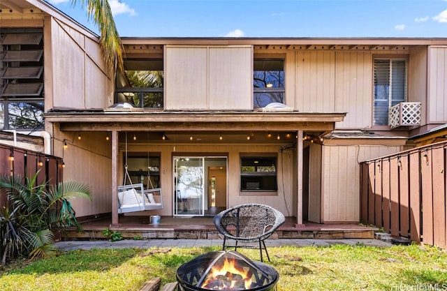 back of house featuring a fire pit