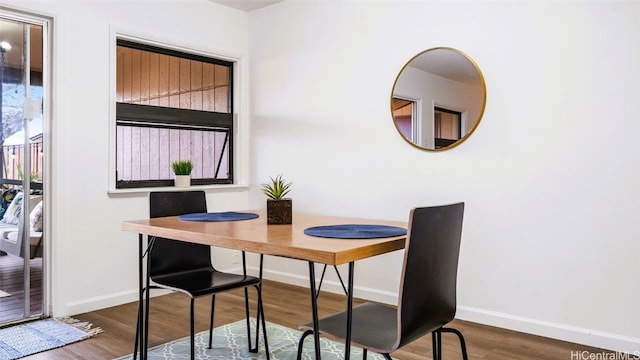 dining area with dark hardwood / wood-style flooring