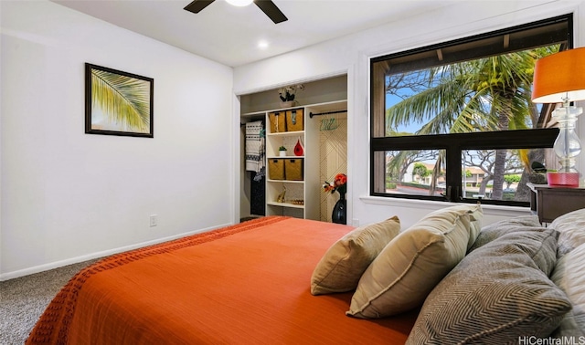 carpeted bedroom featuring a closet and ceiling fan