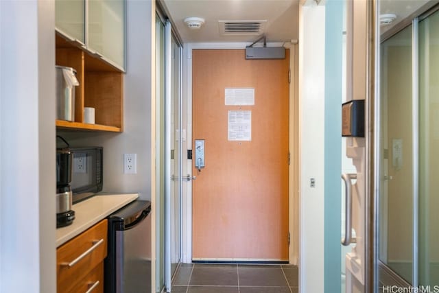 entryway featuring dark tile patterned flooring