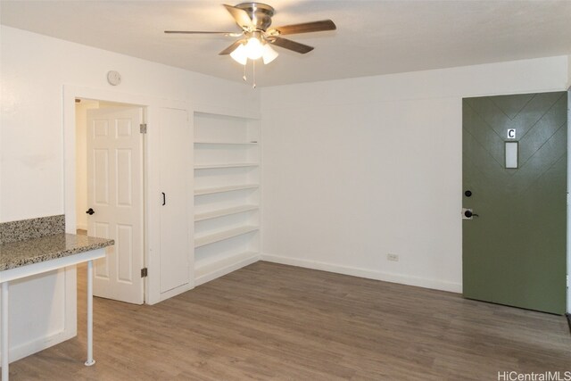 unfurnished room with ceiling fan and dark hardwood / wood-style flooring