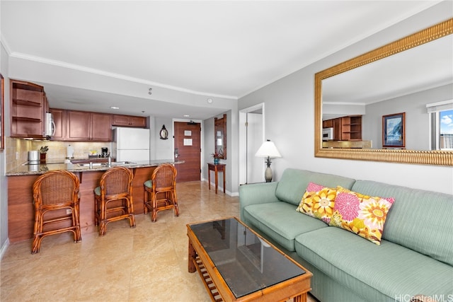 living room featuring ornamental molding and light tile patterned floors