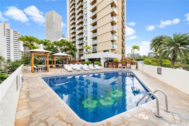 view of swimming pool with a gazebo and a patio area