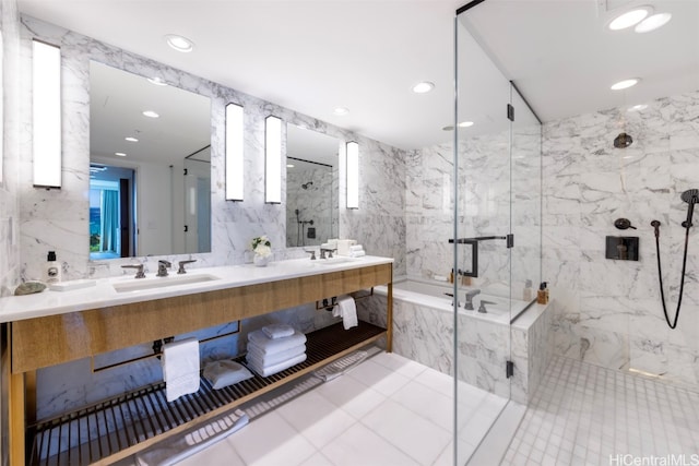 bathroom featuring tile walls, vanity, plus walk in shower, and tile patterned floors