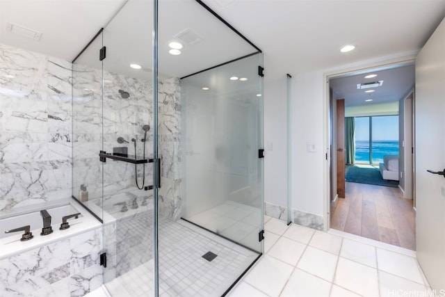 bathroom featuring plus walk in shower and wood-type flooring