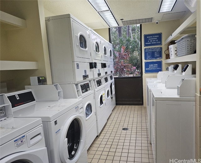 washroom with independent washer and dryer, stacked washer and dryer, and light tile patterned floors