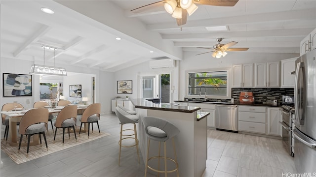 kitchen featuring vaulted ceiling with beams, a wall mounted air conditioner, sink, white cabinetry, and appliances with stainless steel finishes