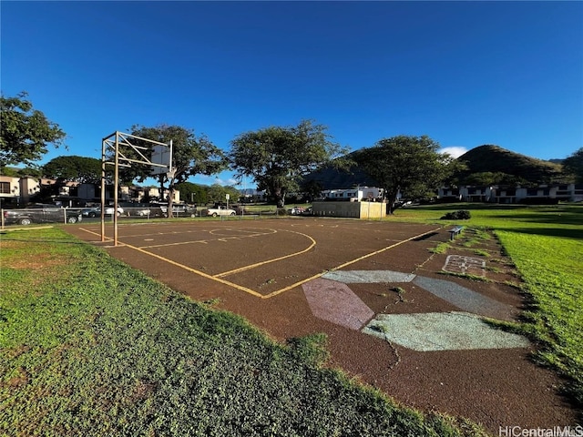 view of basketball court with a yard and a mountain view